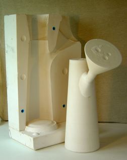 Model and 3 part vertically split block with a "bunged" spout feed